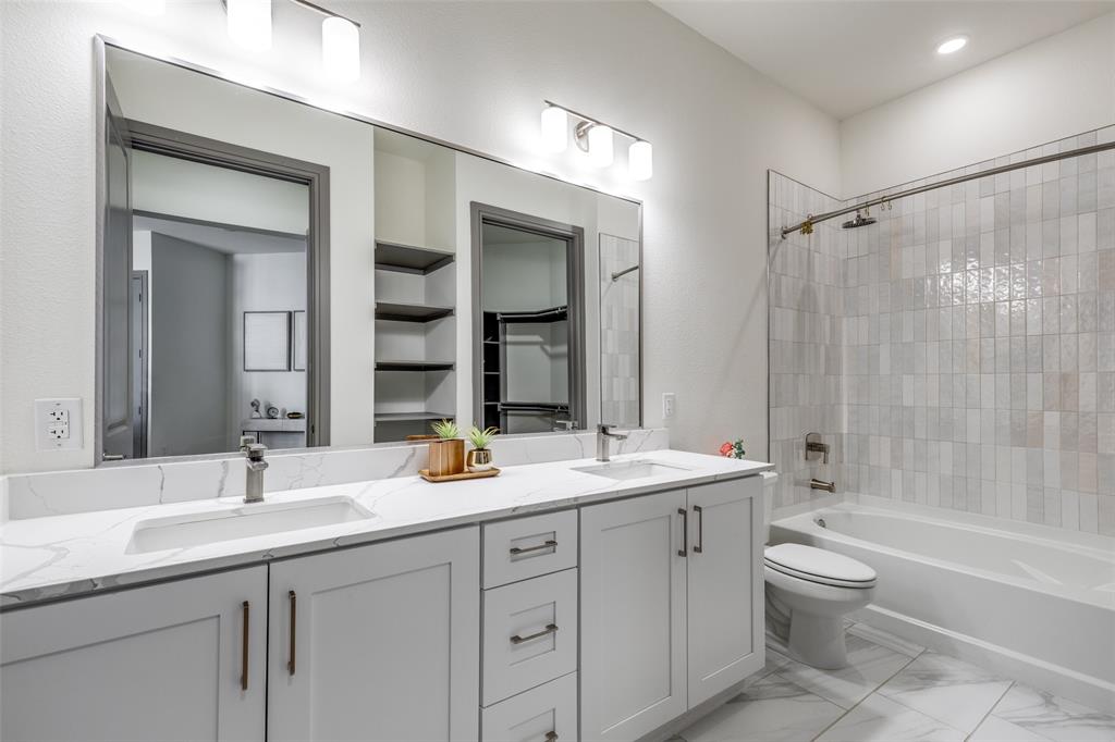 2700 Old Denton Road, Unit 3350 Carrollton, TX 75007 - Photo 7 of 12 a bathroom with a double vanity sink toilet mirror and bathtub