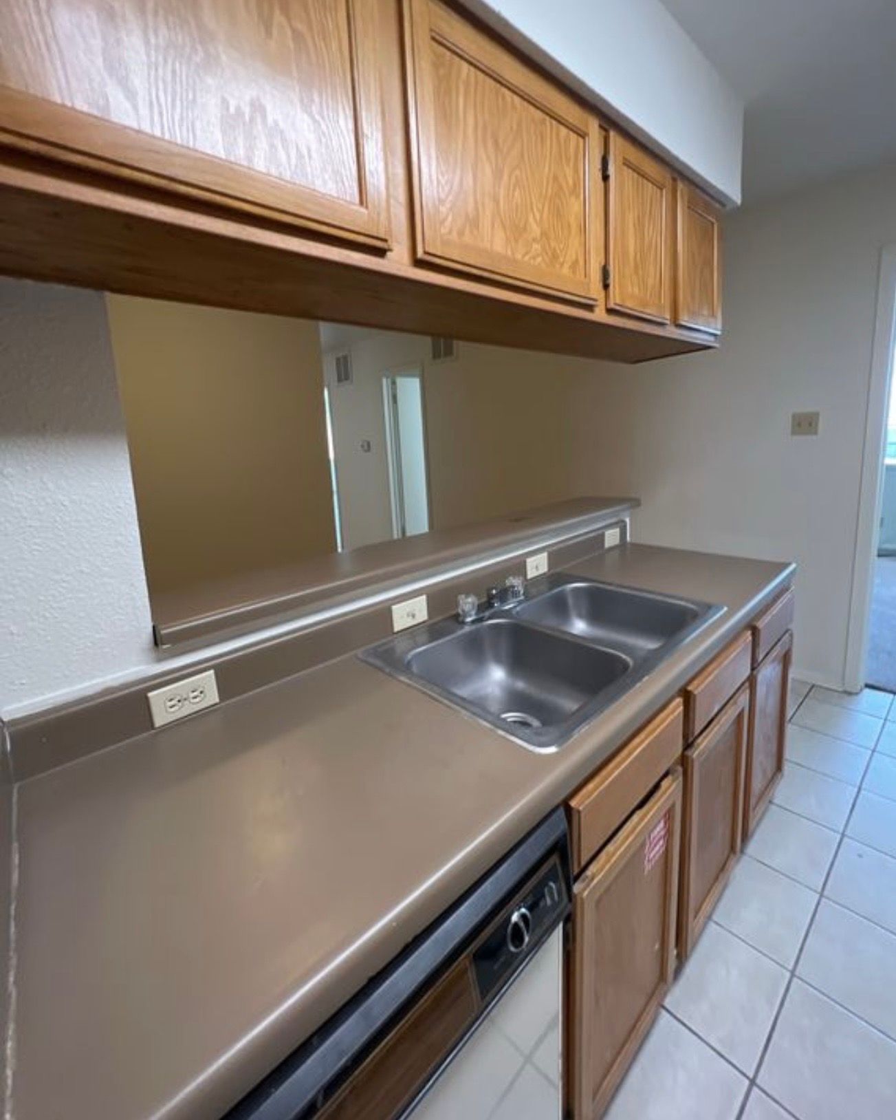 3115 Helms Street, Unit 111 Austin, TX 78705 - Photo 2 of 13 Functional kitchen with ample cabinetry and a practical double sink for everyday tasks.