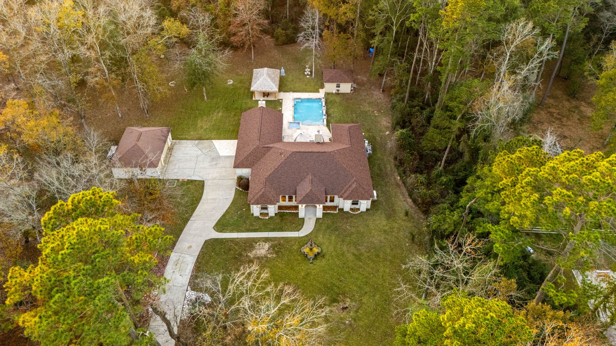 There is so much to this home! Long private drive with gated entry, large pool, air conditioned sunroom, palapa and outdoor kitchen, gas fire pit and large open interior