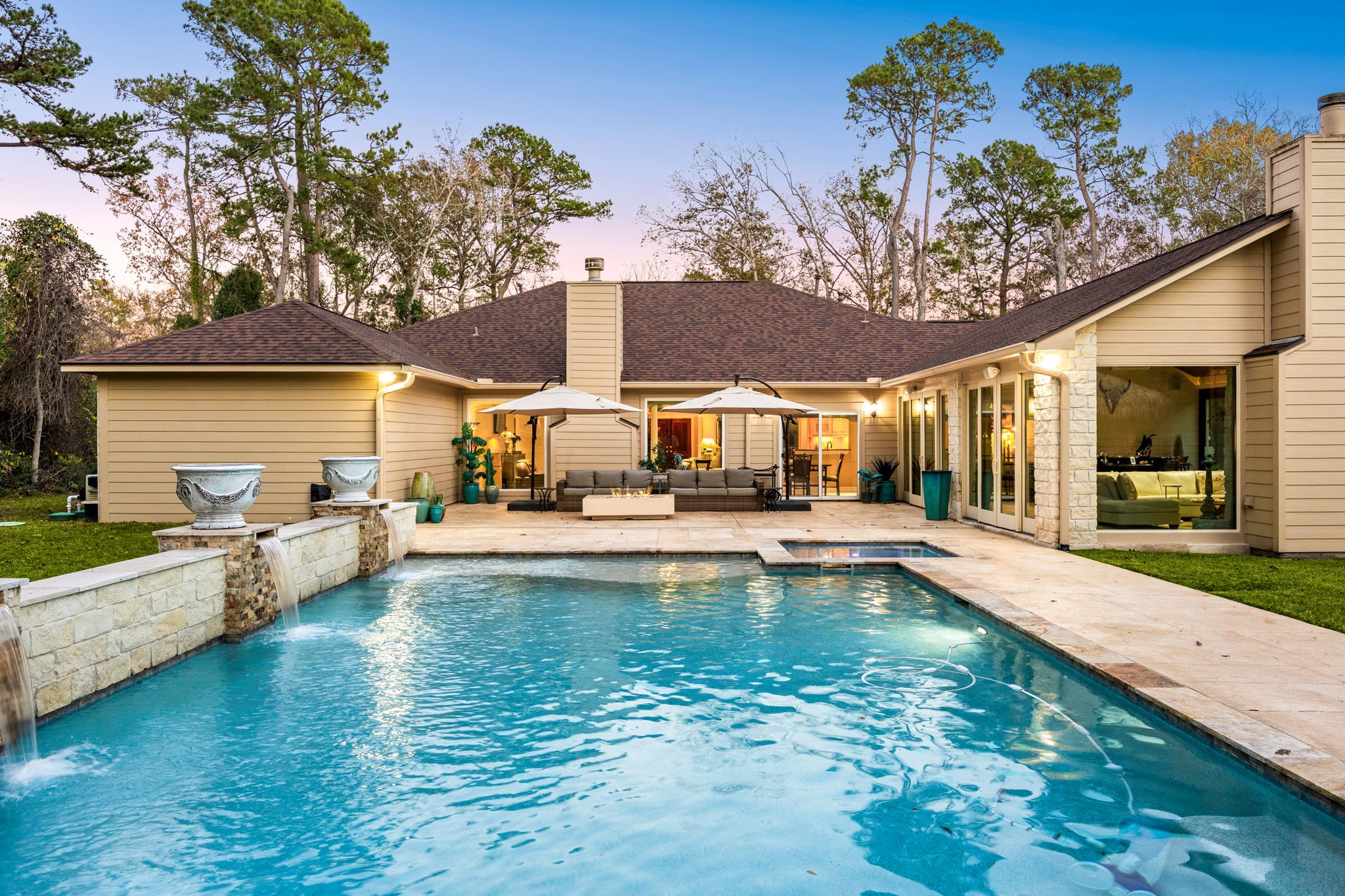 11984 White Oak Crossing Conroe, TX 77385 - Photo 3 of 42 Gorgeous modern style pool with hot tub, waterfall feature, gas firepit and lounge area