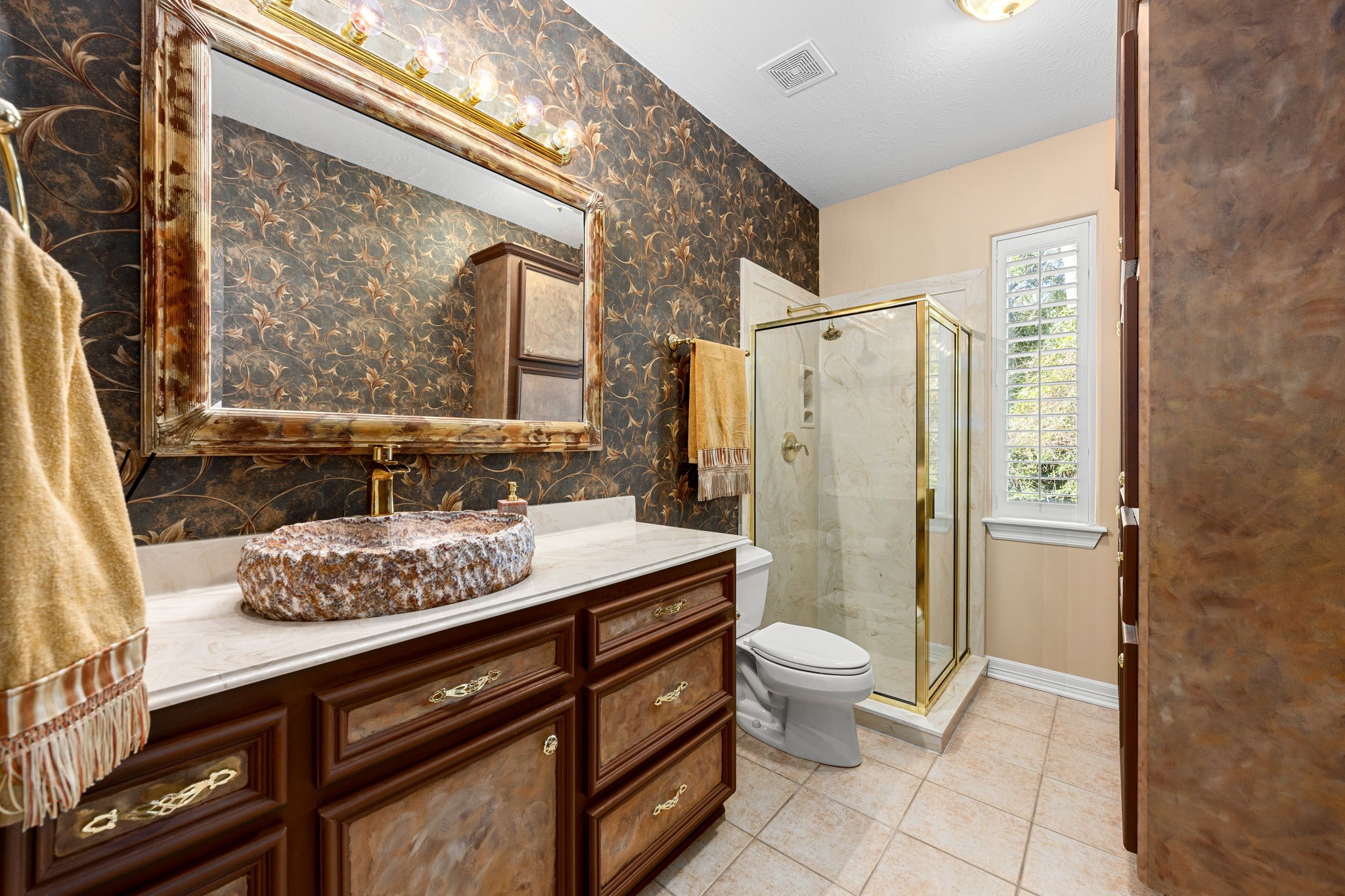 11984 White Oak Crossing Conroe, TX 77385 - Photo 33 of 42 The additional secondary bathroom is adorned with custom cabinet finishes and custom sink hewn from a single piece of onyx