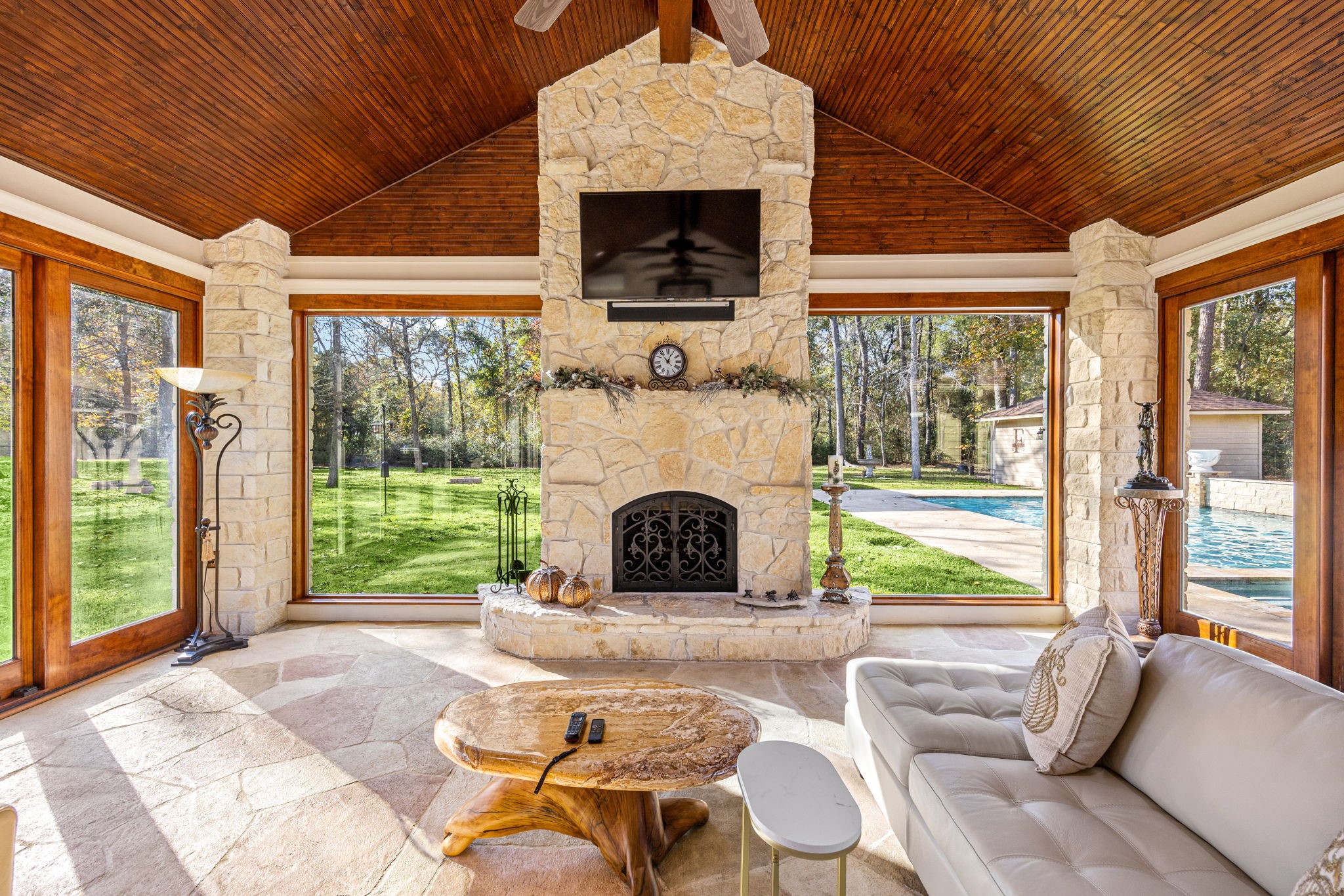 11984 White Oak Crossing Conroe, TX 77385 - Photo 8 of 42 Enjoy the beautiful stone fireplace, watch your favorite college games and easily step out to the pool area for a splash, then come back and cool off in the AC