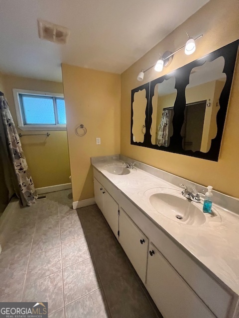 527 Sullivan Road Warner Robins, GA 31093 - Photo 17 of 34 a bathroom with a double vanity sink and a mirror
