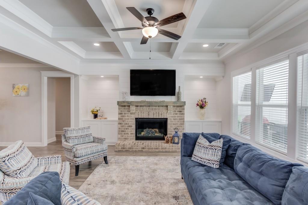 525 Storey Lane Jefferson, GA 30549 - Photo 12 of 45 a living room with furniture a flat screen tv and a fireplace