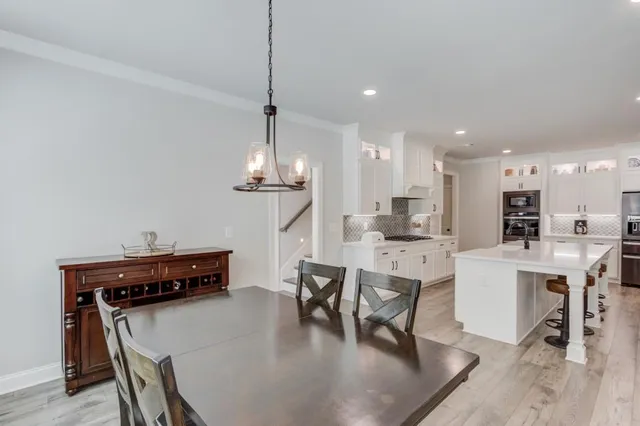 a view of kitchen with cabinets table and chairs