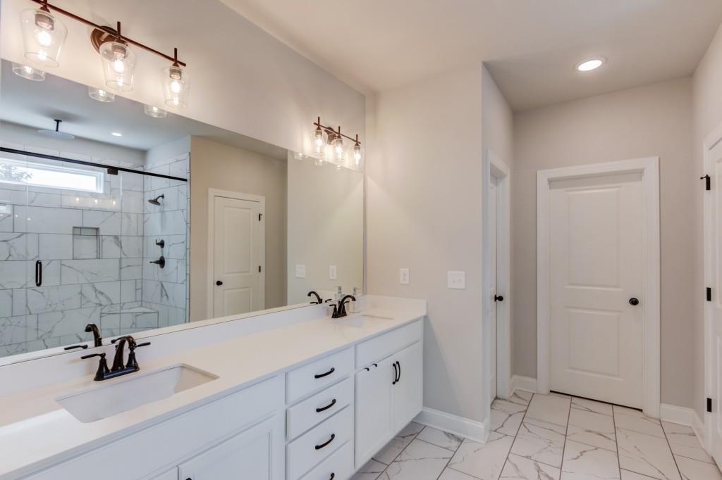 525 Storey Lane Jefferson, GA 30549 - Photo 21 of 45 a bathroom with double sink and a mirror
