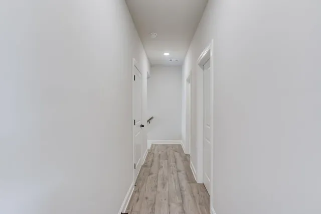 a living room with furniture and hard wood floor