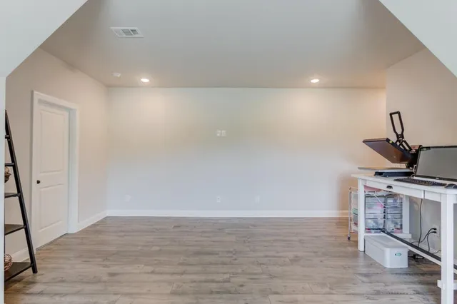 a bedroom with a bed and flat screen tv
