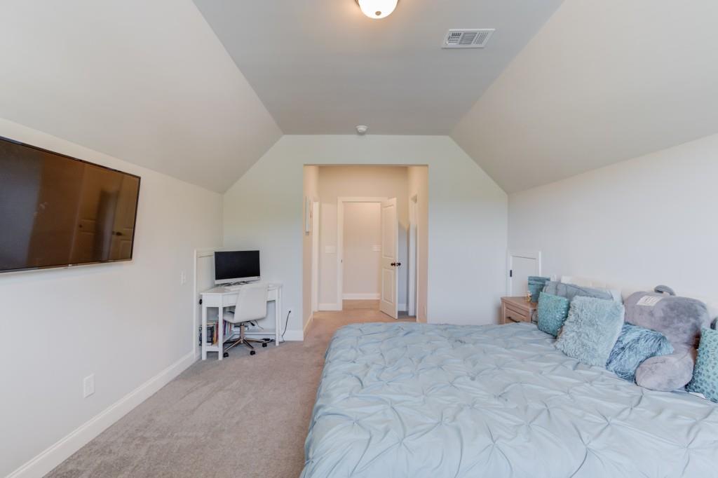 525 Storey Lane Jefferson, GA 30549 - Photo 33 of 45 a spacious bedroom with a bed and chair