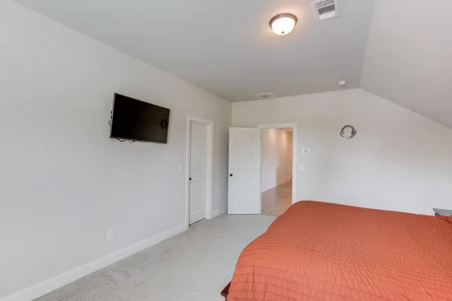 a bathroom with a sink a toilet a mirror and shower