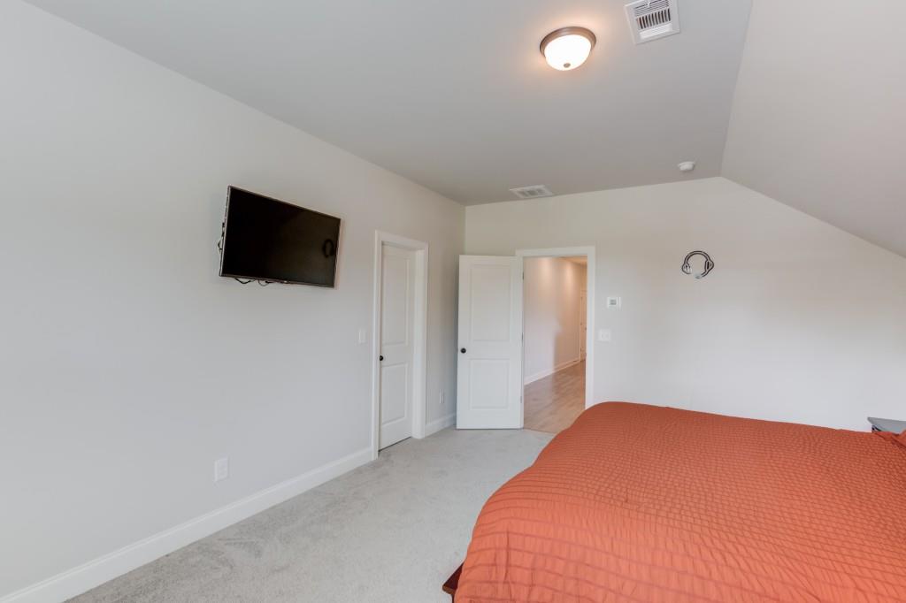 525 Storey Lane Jefferson, GA 30549 - Photo 36 of 45 a bedroom with a bed and a flat screen tv