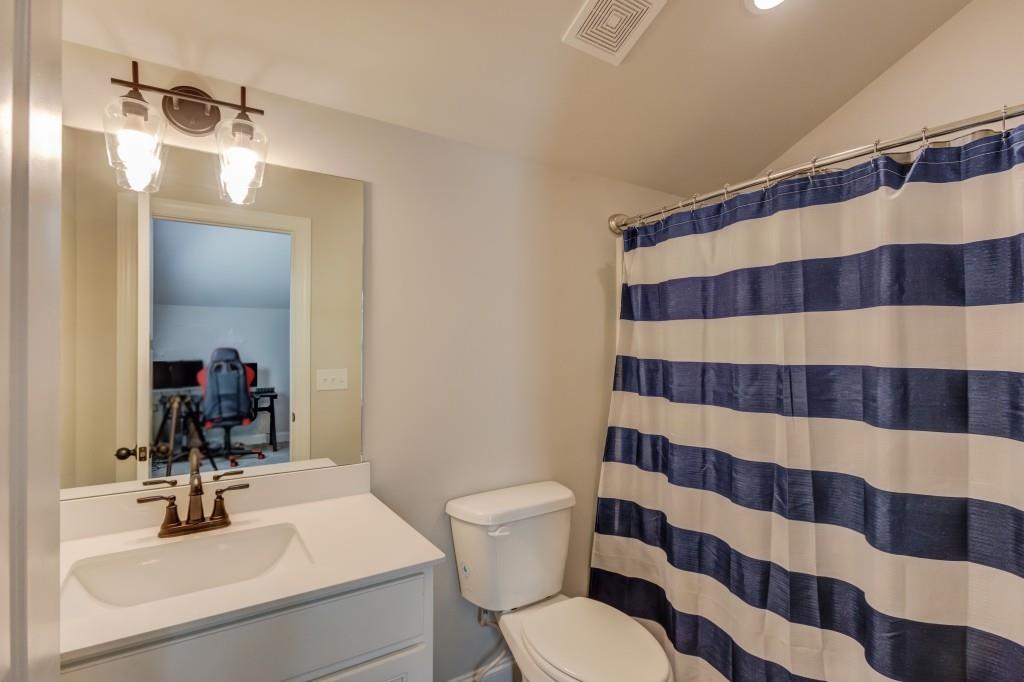 525 Storey Lane Jefferson, GA 30549 - Photo 37 of 45 a bathroom with a sink a toilet a mirror and shower