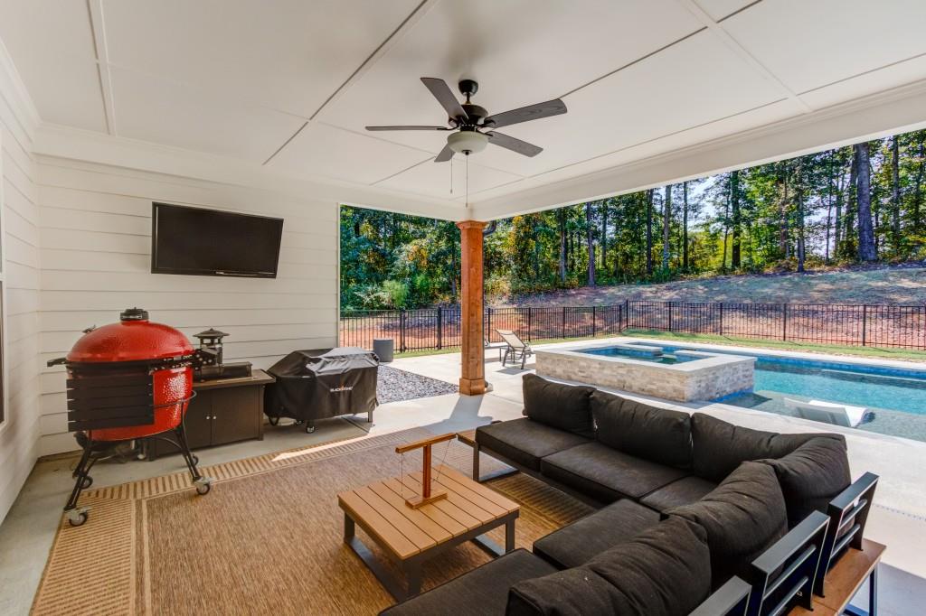 525 Storey Lane Jefferson, GA 30549 - Photo 38 of 45 a living room with furniture and a flat screen tv