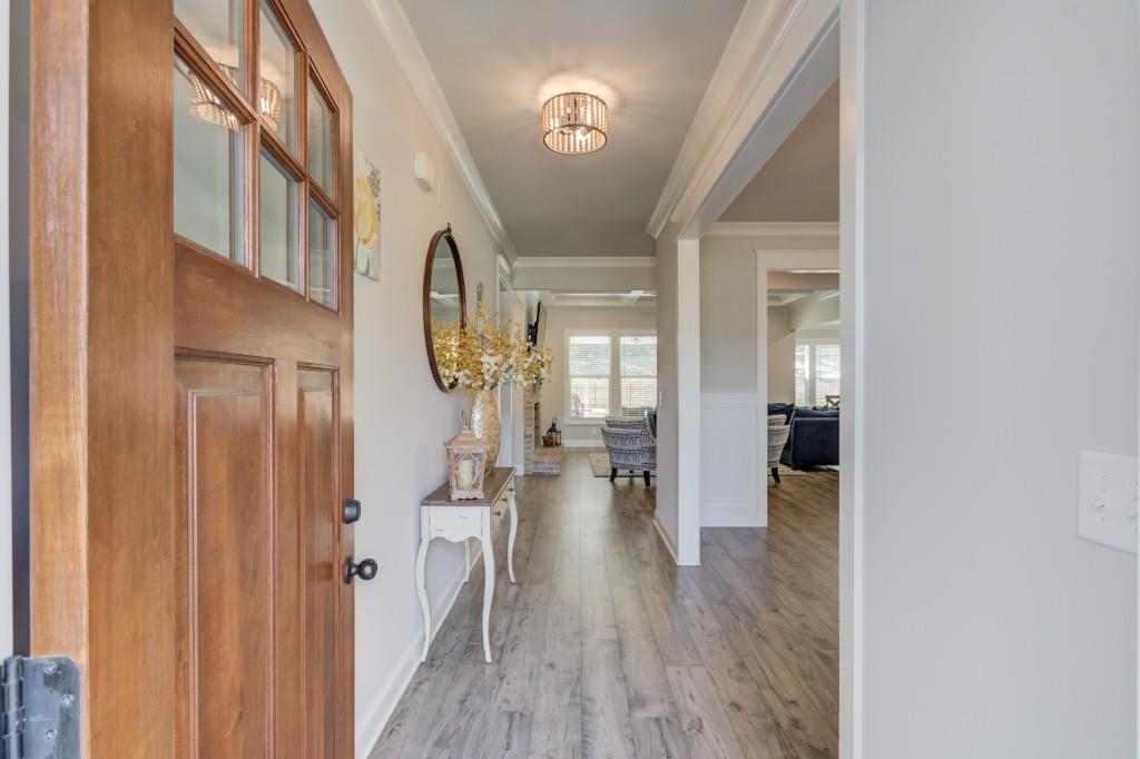 525 Storey Lane Jefferson, GA 30549 - Photo 6 of 45 a view of a hallway with wooden floor fireplace and living room