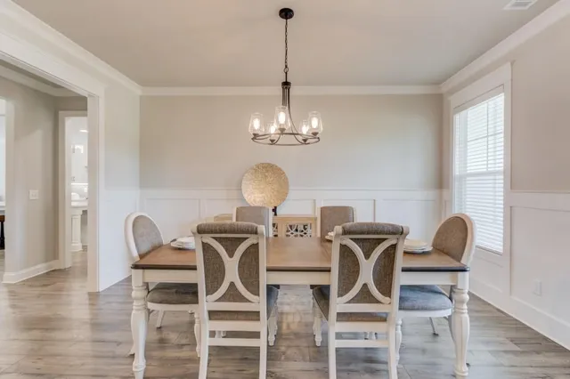 a view of a dining room with furniture and wooden floor