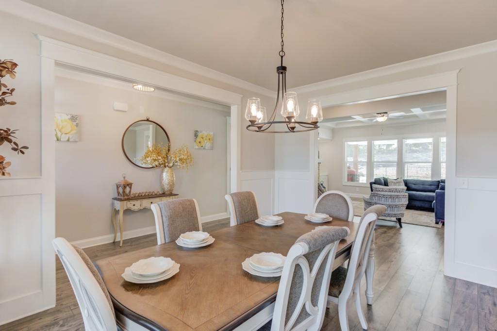 525 Storey Lane Jefferson, GA 30549 - Photo 9 of 45 a view of a dining room with furniture a chandelier and wooden floor