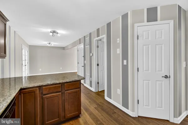 a view of a kitchen with granite countertop cabinets