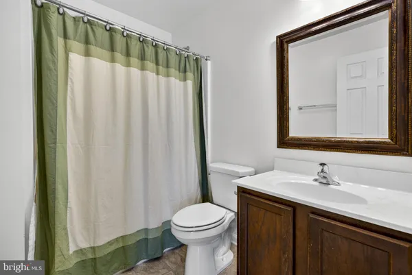 a bathroom with a sink a toilet and a mirror