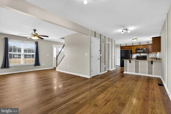 a view of a kitchen with wooden floor and a kitchen