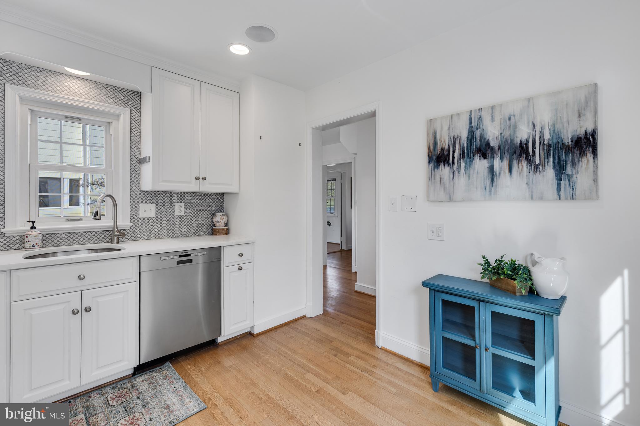 314 Whitestone Road Silver Spring, MD 20901 - Photo 12 of 36 a kitchen with white cabinets a sink and dishwasher