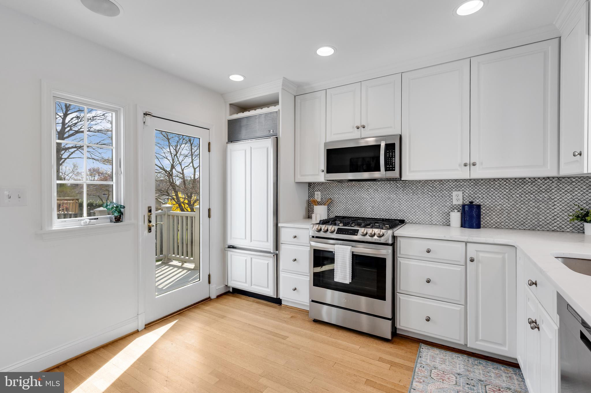 314 Whitestone Road Silver Spring, MD 20901 - Photo 14 of 35 a kitchen with stainless steel appliances white cabinets and a stove top oven
