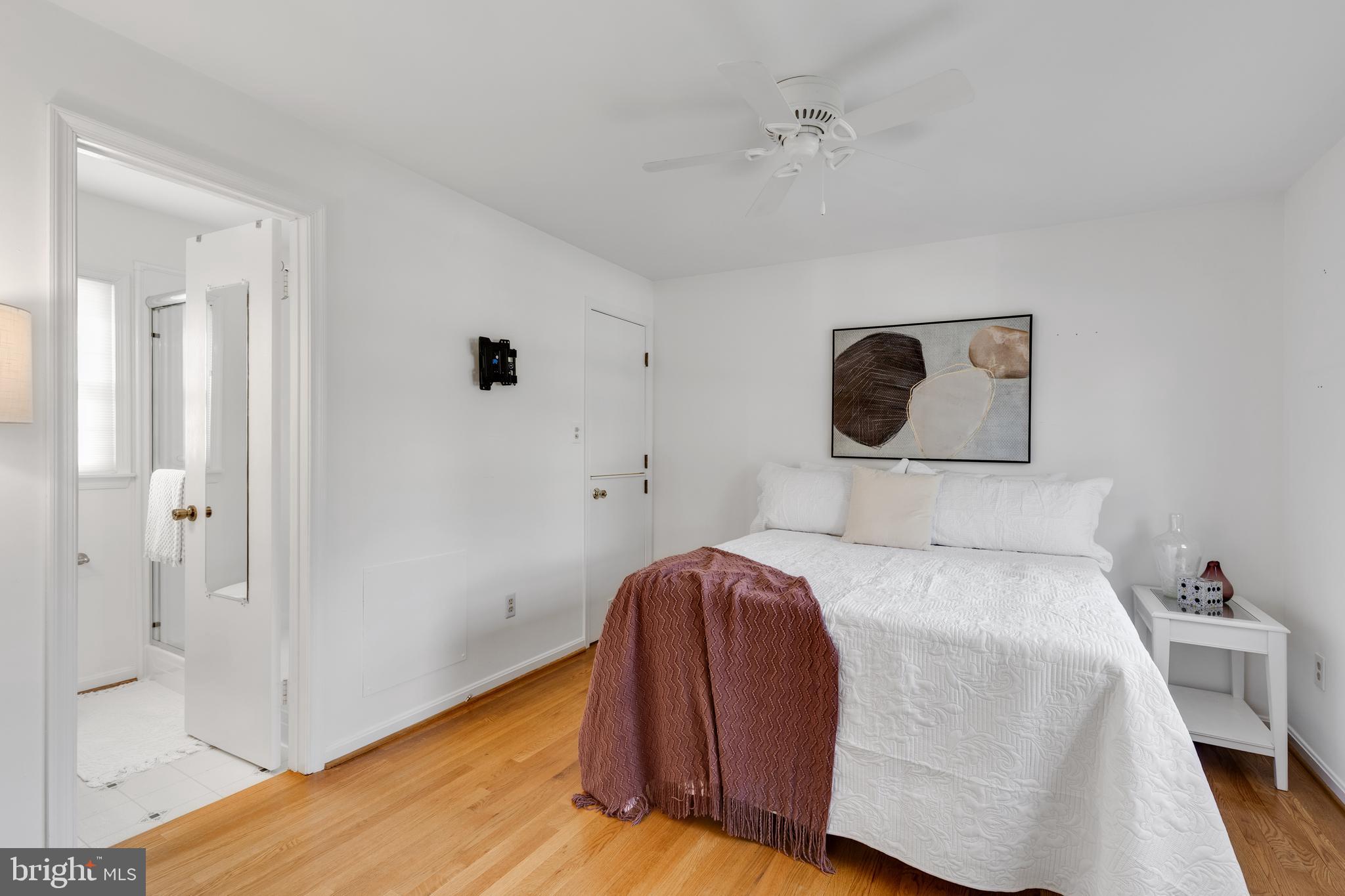 314 Whitestone Road Silver Spring, MD 20901 - Photo 15 of 35 a bedroom with a bed and a lamp