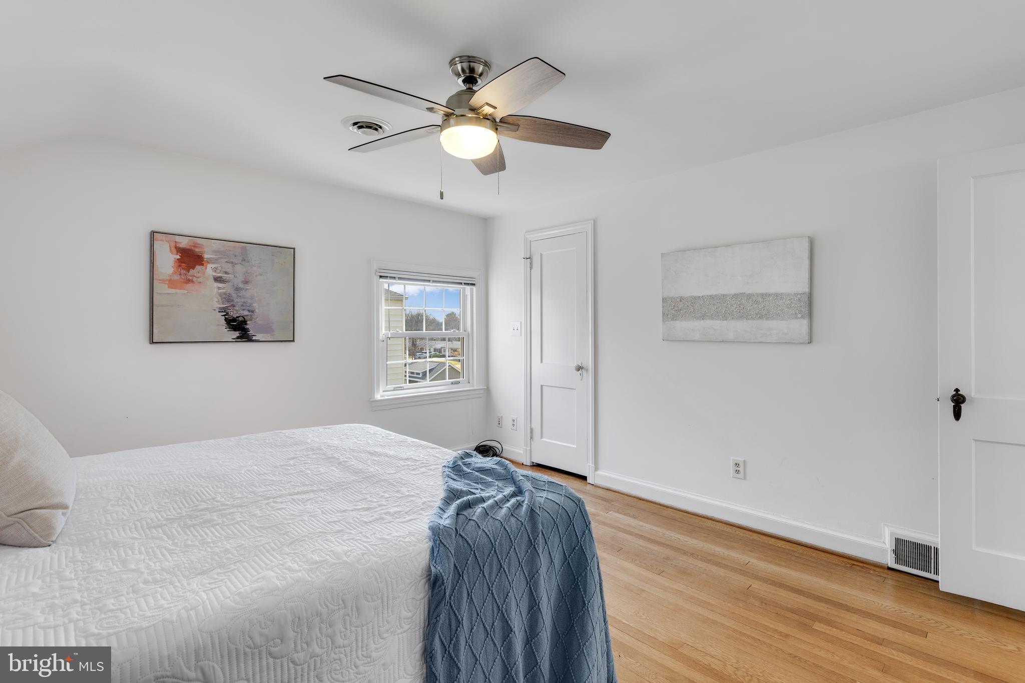 314 Whitestone Road Silver Spring, MD 20901 - Photo 20 of 35 a bedroom with a large bed and a chandelier