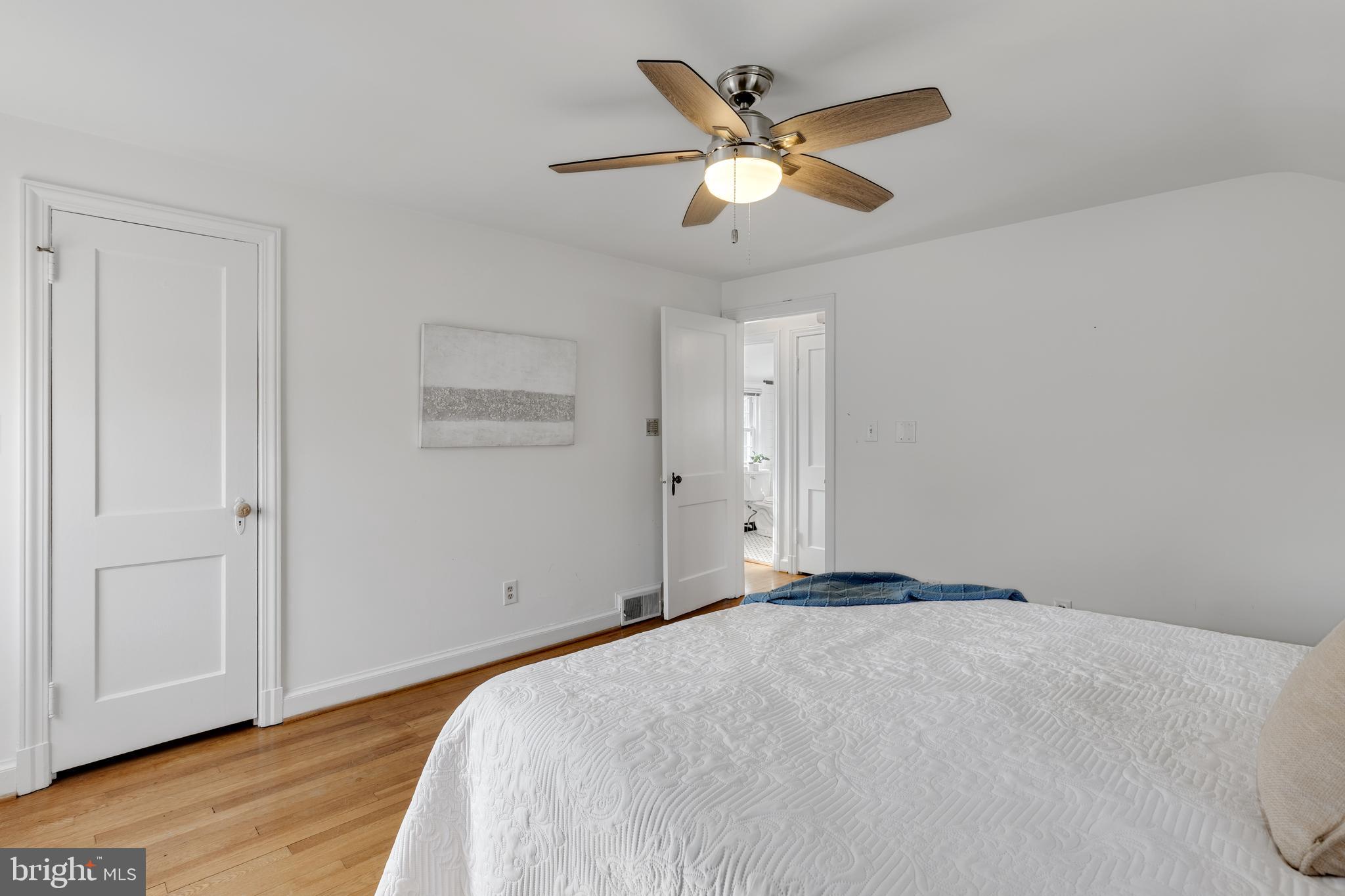 314 Whitestone Road Silver Spring, MD 20901 - Photo 22 of 36 a bedroom with a large bed and a chandelier