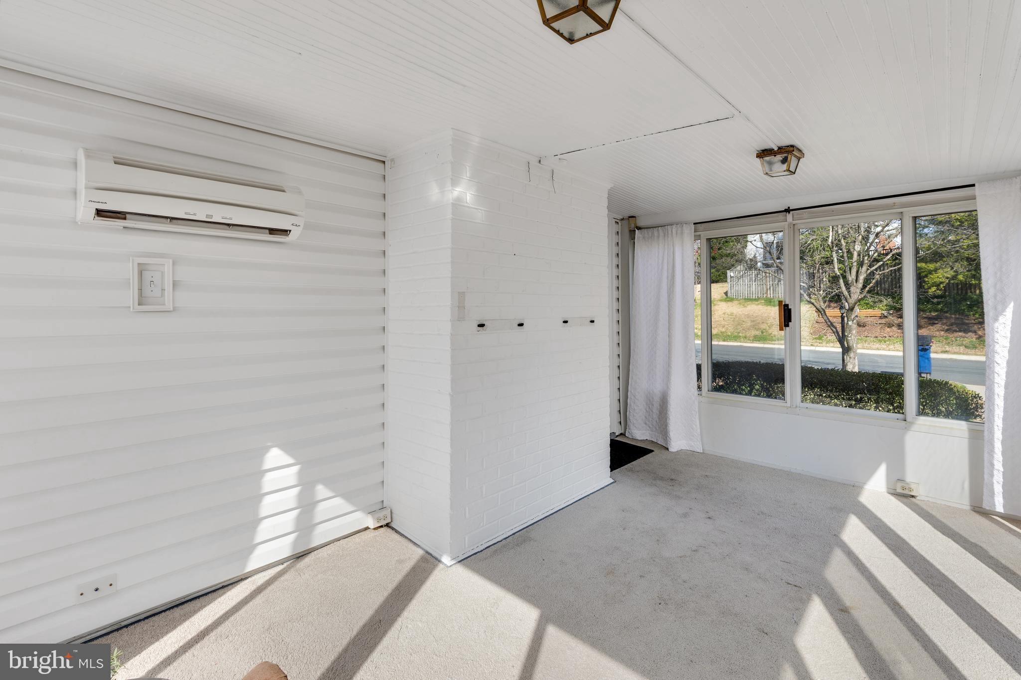 314 Whitestone Road Silver Spring, MD 20901 - Photo 6 of 36 a bedroom with a bed and large window with balcony view