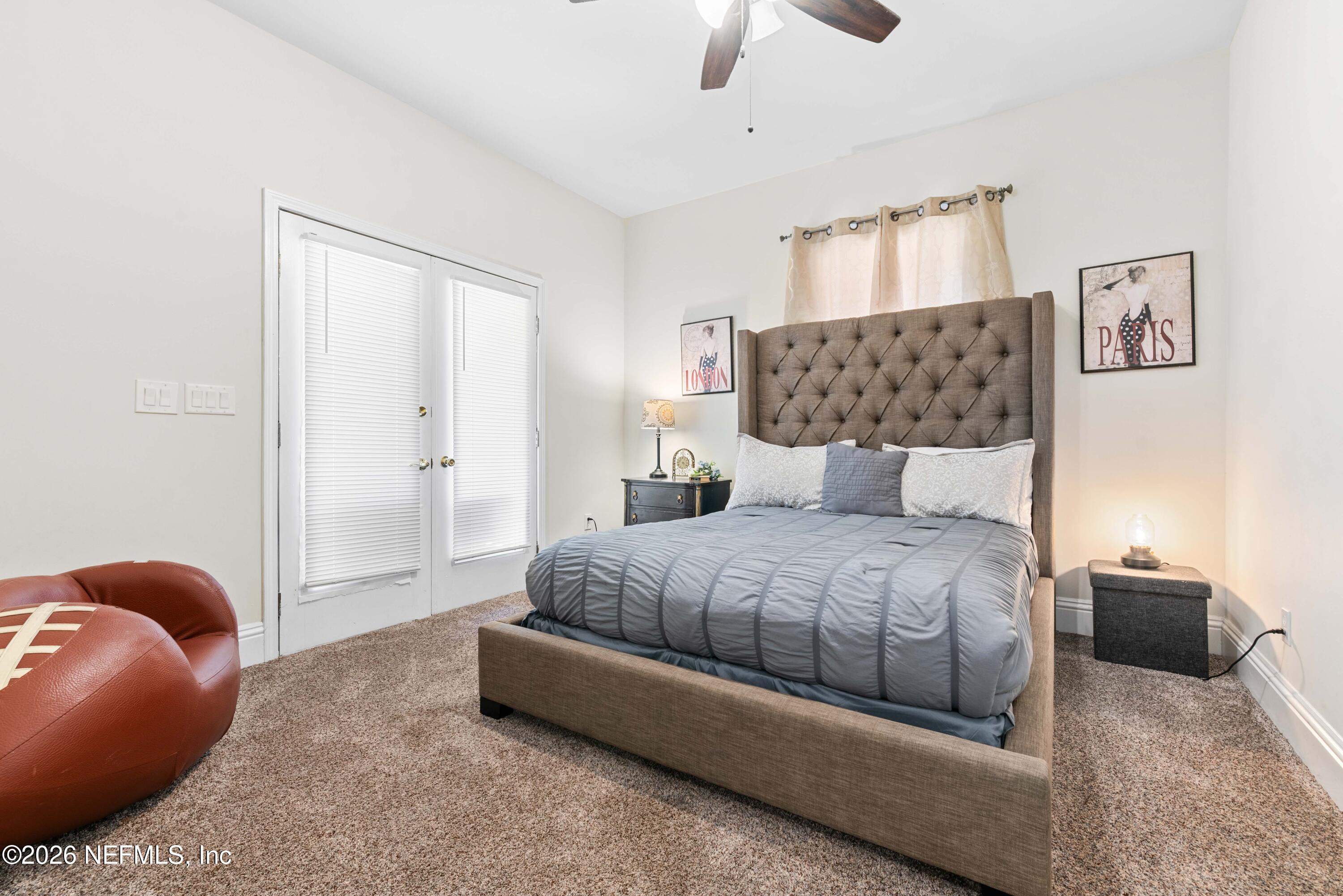 1138 Walnut Street Jacksonville, FL 32206 - Photo 14 of 37 a bedroom with a bed and ceiling fan