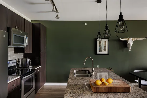 a kitchen with sink and stainless steel appliances