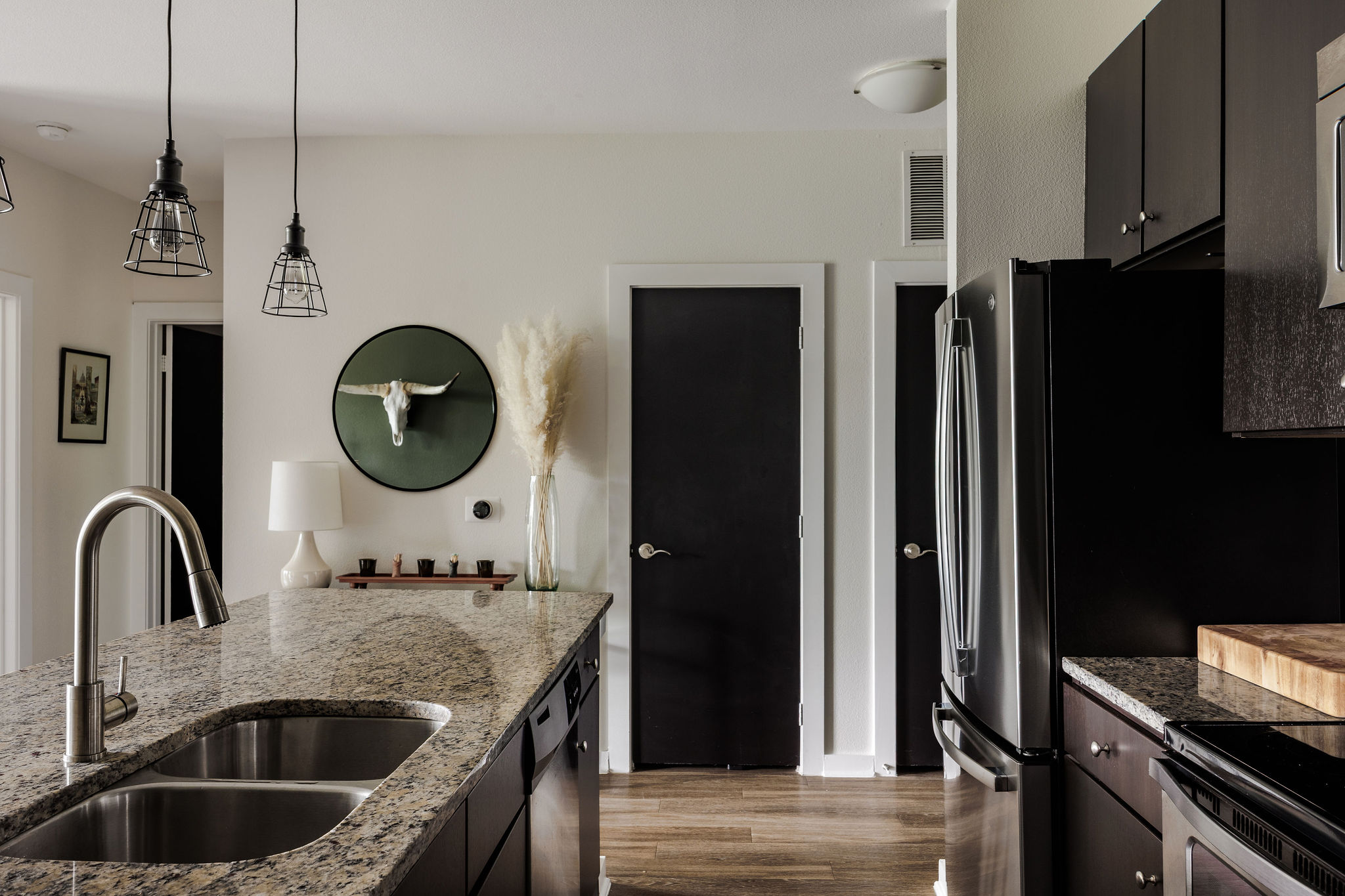 1900 Barton Springs Road, Unit 3028 Austin, TX 78704 - Photo 13 of 31 a kitchen with kitchen island a refrigerator and a sink