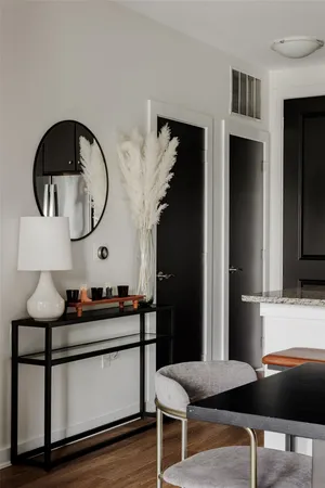 a living room with furniture and a mirror