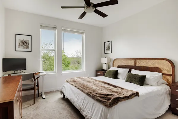 a bedroom with a bed and a desk