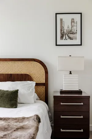 a bedroom with a bed and a painting on the wall