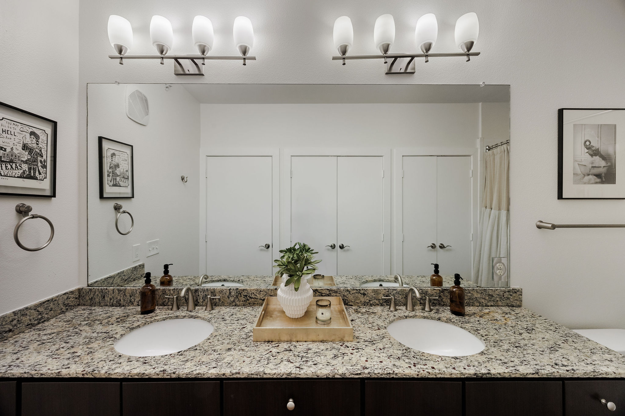 1900 Barton Springs Road, Unit 3028 Austin, TX 78704 - Photo 19 of 31 a bathroom with double vanity sinks and a mirror