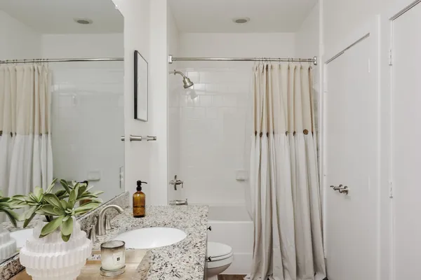 a bath room with a sink and a mirror