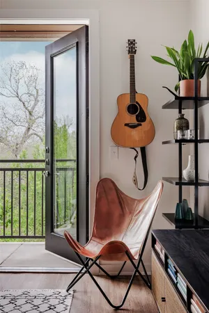a table chair sitting in a room with a potted plant