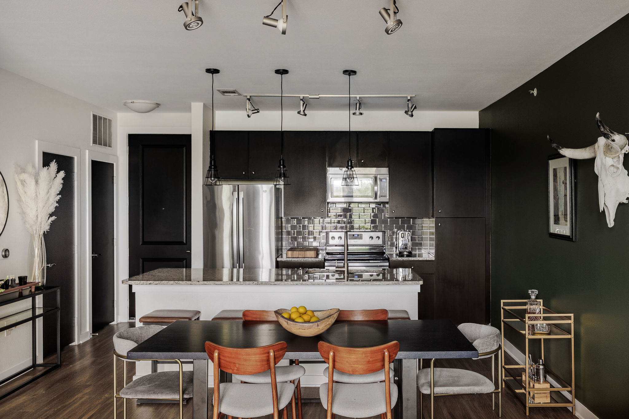 1900 Barton Springs Road, Unit 3028 Austin, TX 78704 - Photo 7 of 31 a dining room with stainless steel appliances kitchen island granite countertop a table and chairs