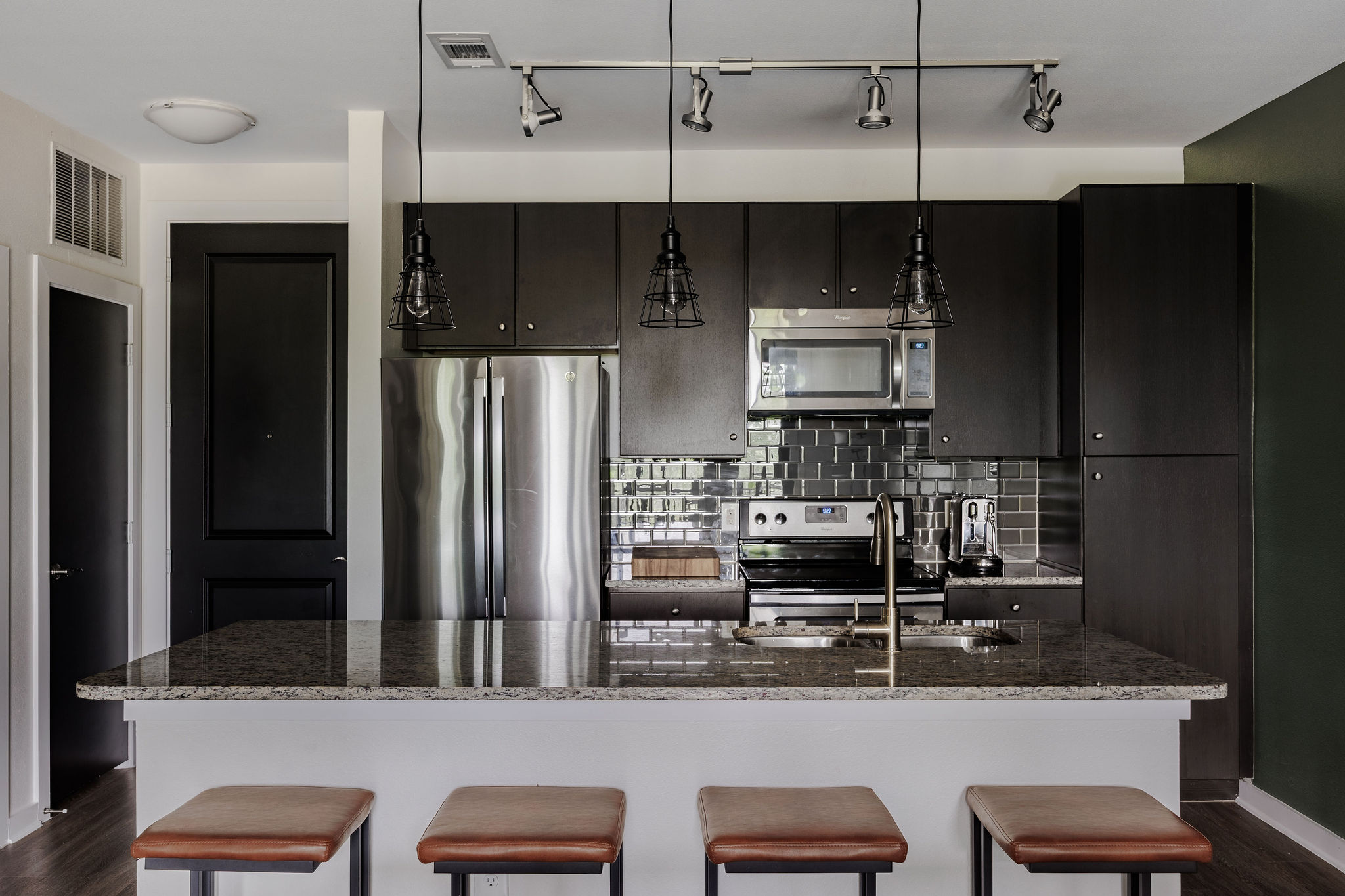 1900 Barton Springs Road, Unit 3028 Austin, TX 78704 - Photo 8 of 31 a kitchen with stainless steel appliances kitchen island granite countertop a refrigerator and a stove top oven
