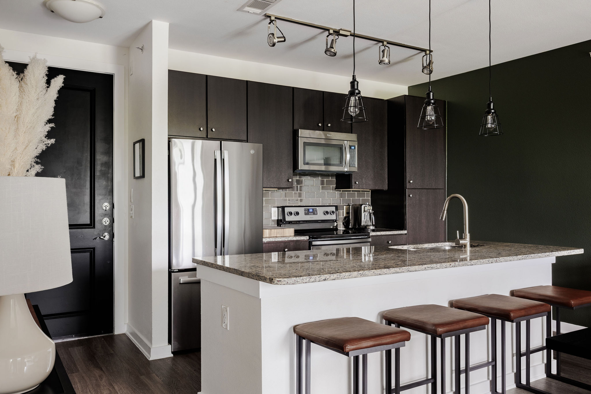 1900 Barton Springs Road, Unit 3028 Austin, TX 78704 - Photo 9 of 31 a kitchen with stainless steel appliances granite countertop a sink refrigerator and cabinets