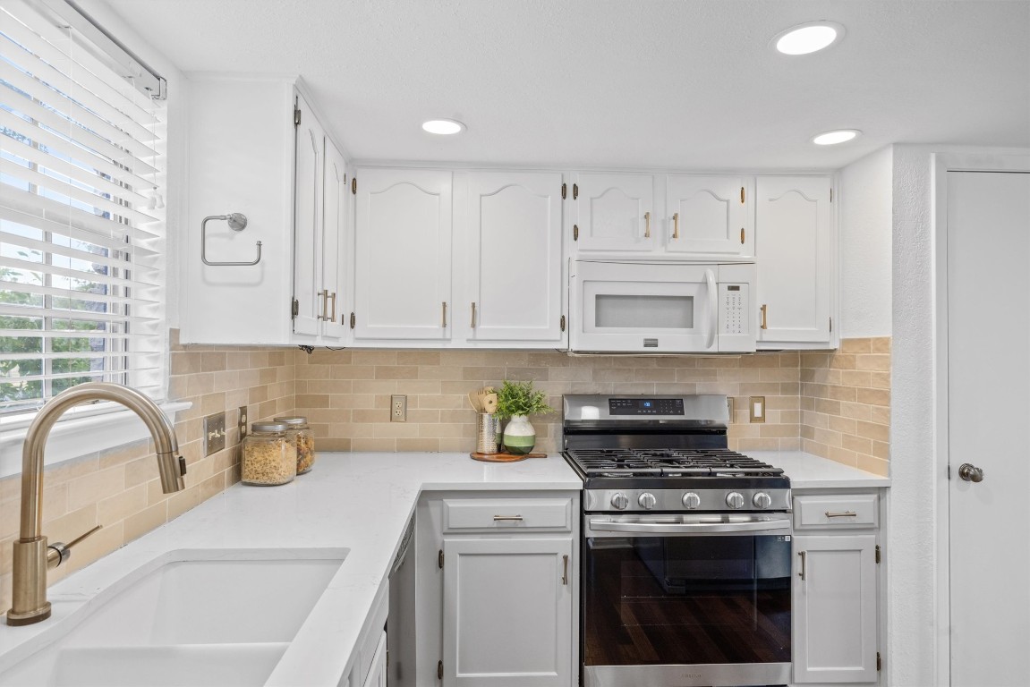 5217 Summerset Trail Austin, TX 78749 - Photo 15 of 38 a kitchen with cabinets a stove and a sink