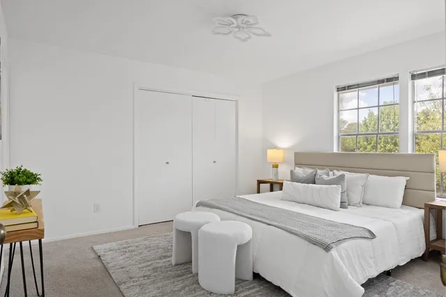 a bedroom with a bed and a potted plant