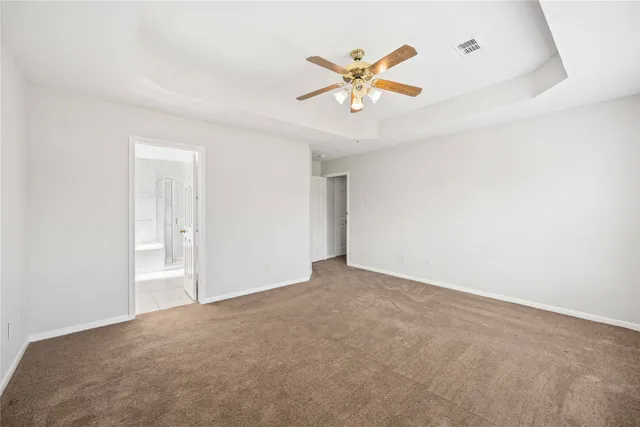 a view of a big room with chandelier fan and windows