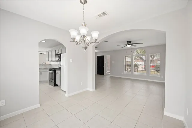 a view of a kitchen with a sink and chandelier