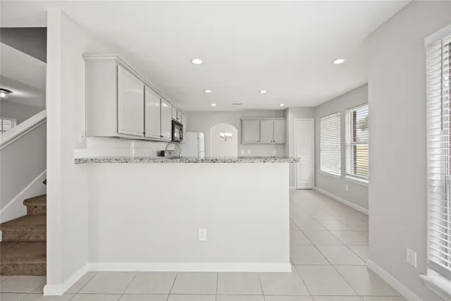 a view of kitchen with stainless steel appliances granite countertop a refrigerator sink and cabinets