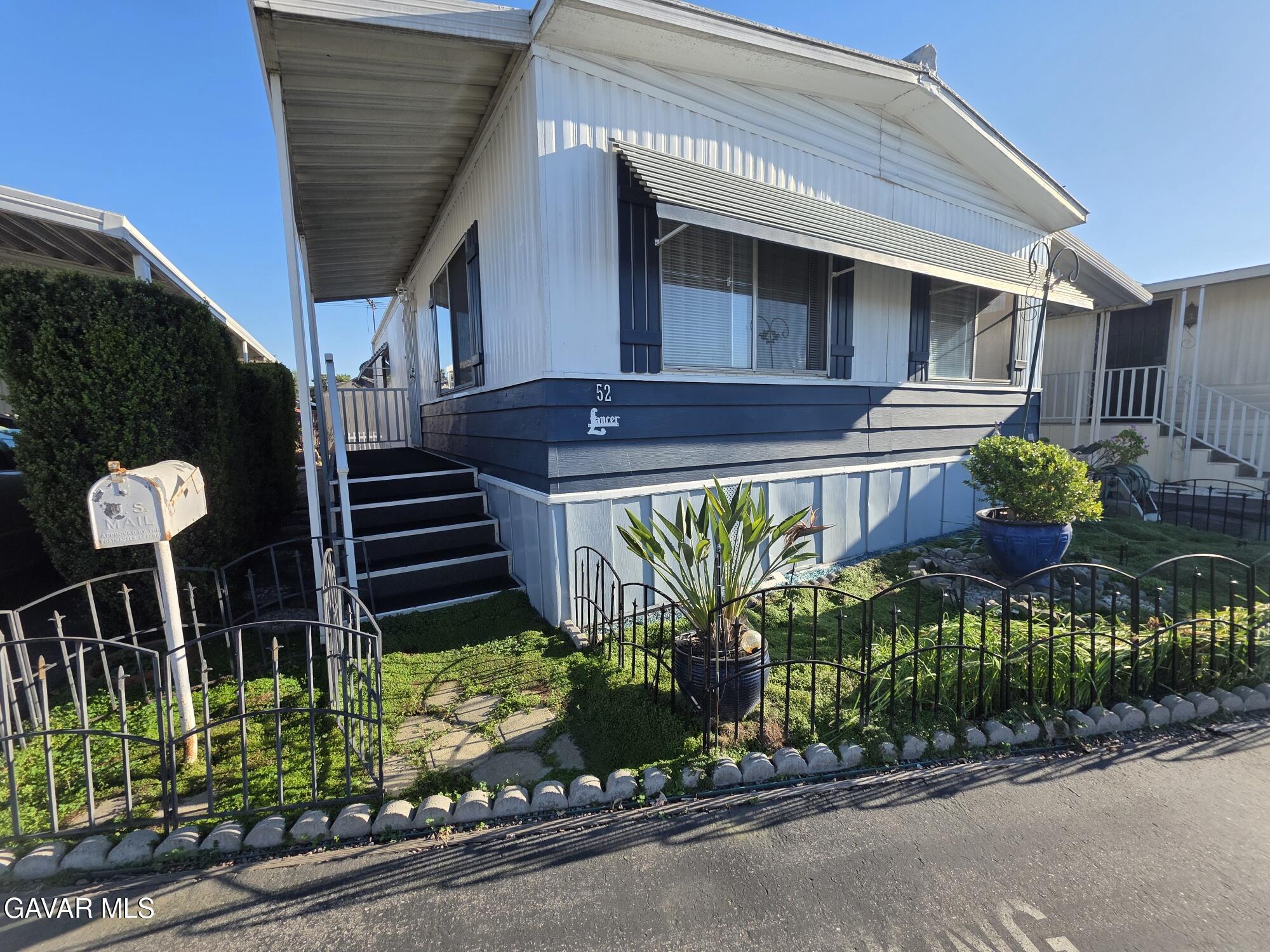 20806 Gridley Road Lakewood, CA 90715 - Photo 13 of 44 a front view of a house with garden