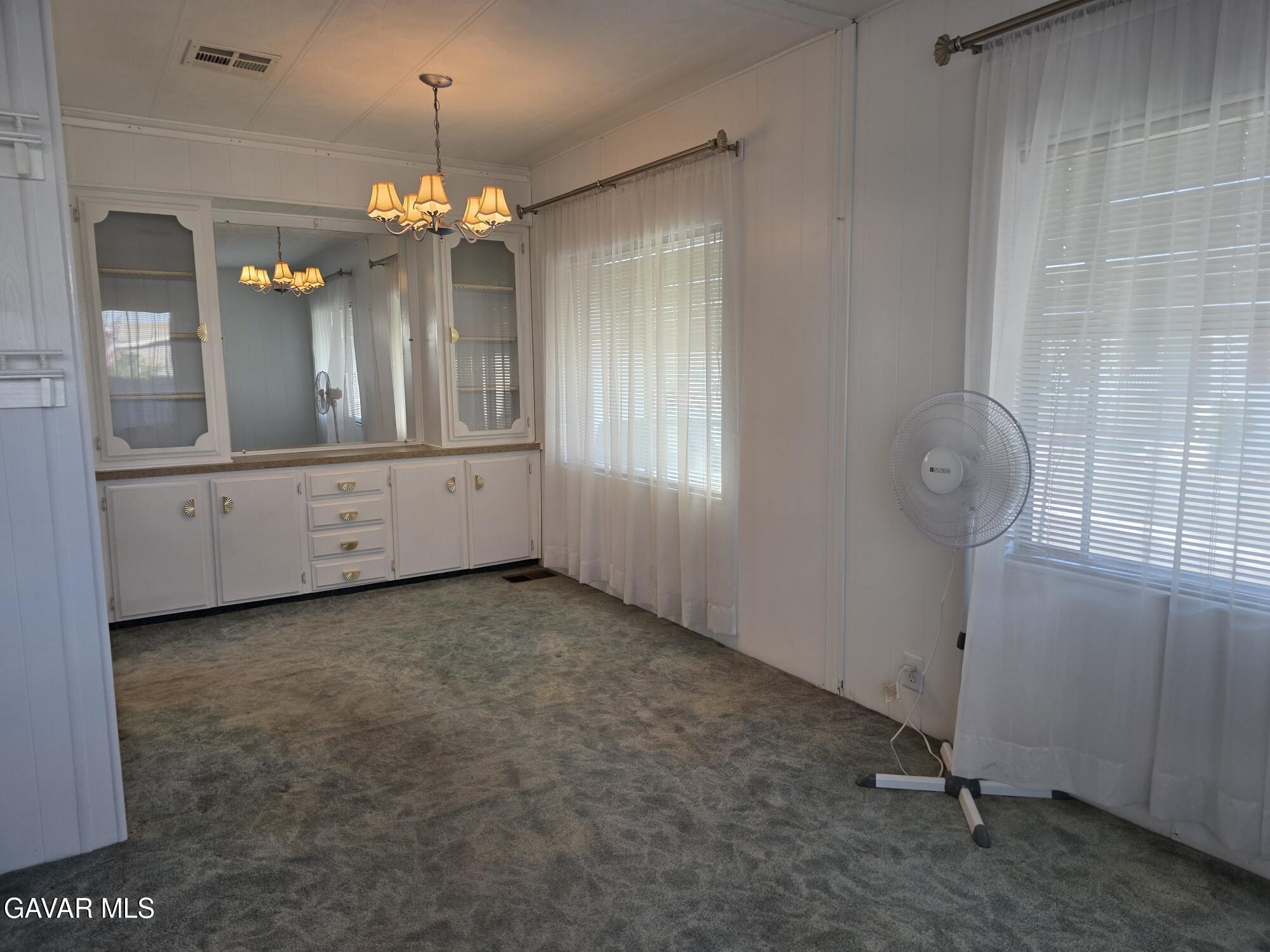 20806 Gridley Road Lakewood, CA 90715 - Photo 15 of 44 a view of a hallway with chandelier