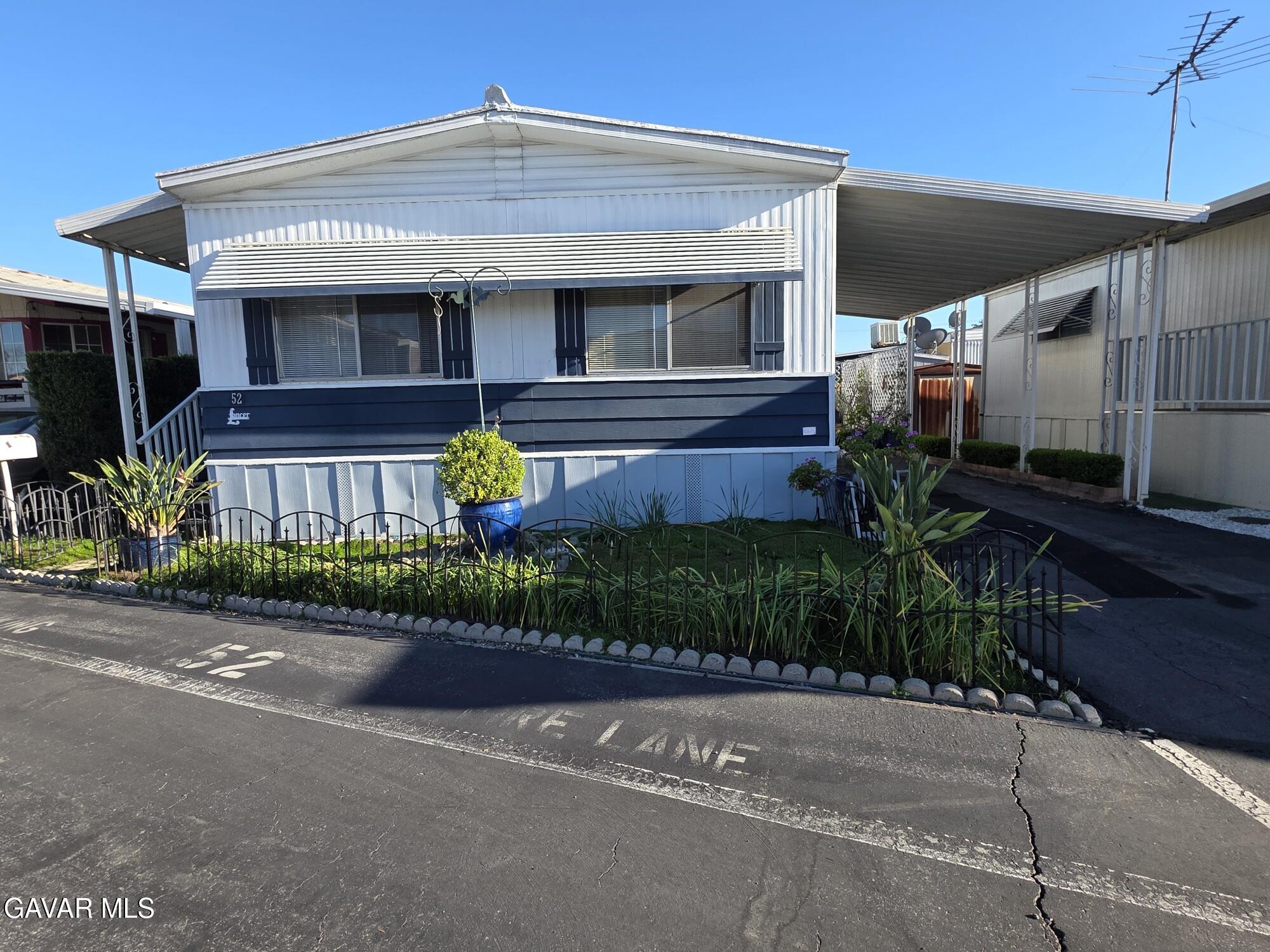 20806 Gridley Road Lakewood, CA 90715 - Photo 2 of 44 a front view of a house with garden