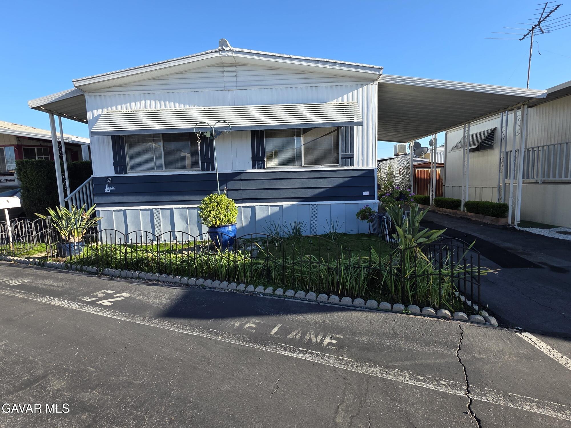 20806 Gridley Road Lakewood, CA 90715 - Photo 3 of 44 a front view of a house with garden